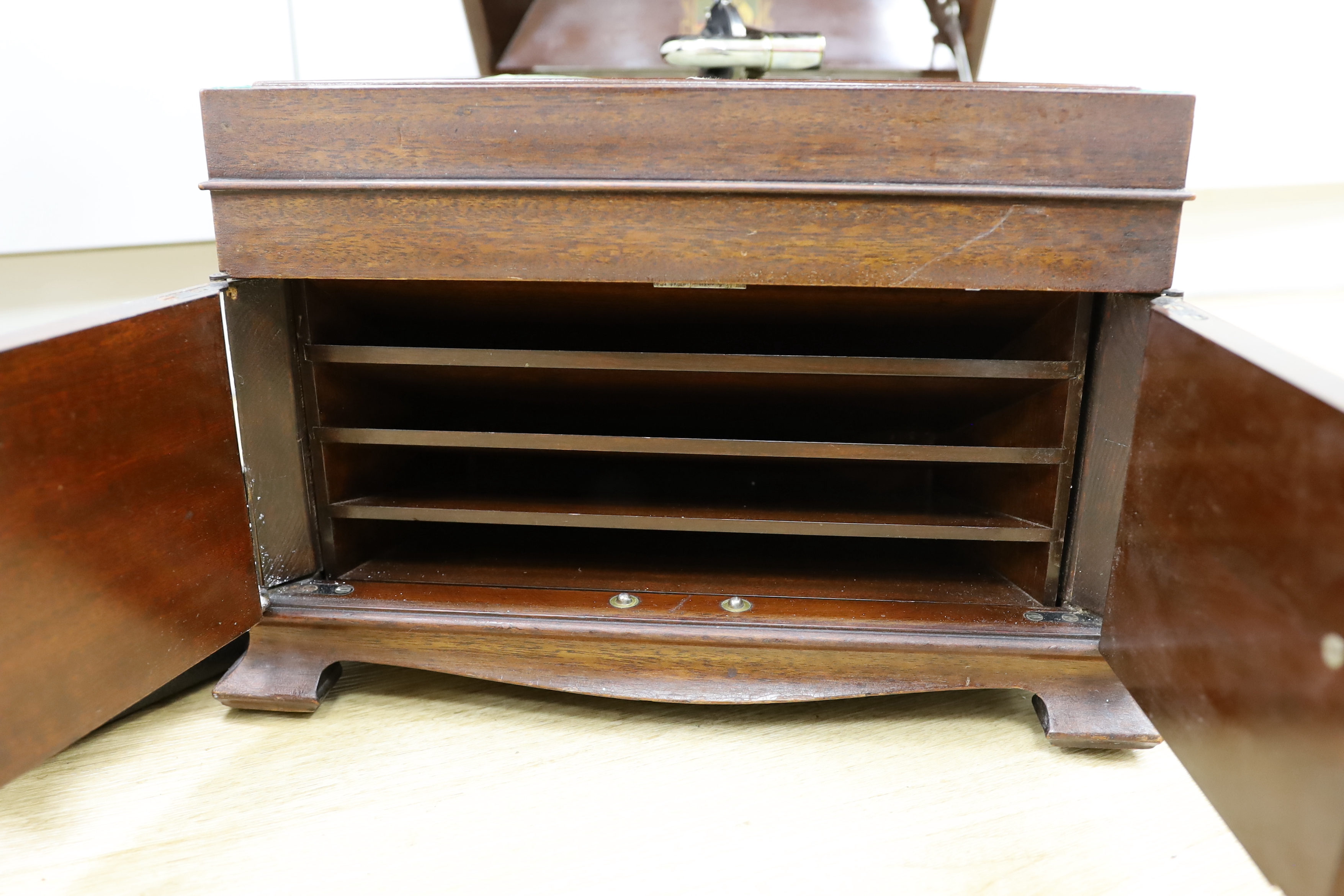 An HMV gramophone and a portable HMV gramophone, together with a small number of 78s